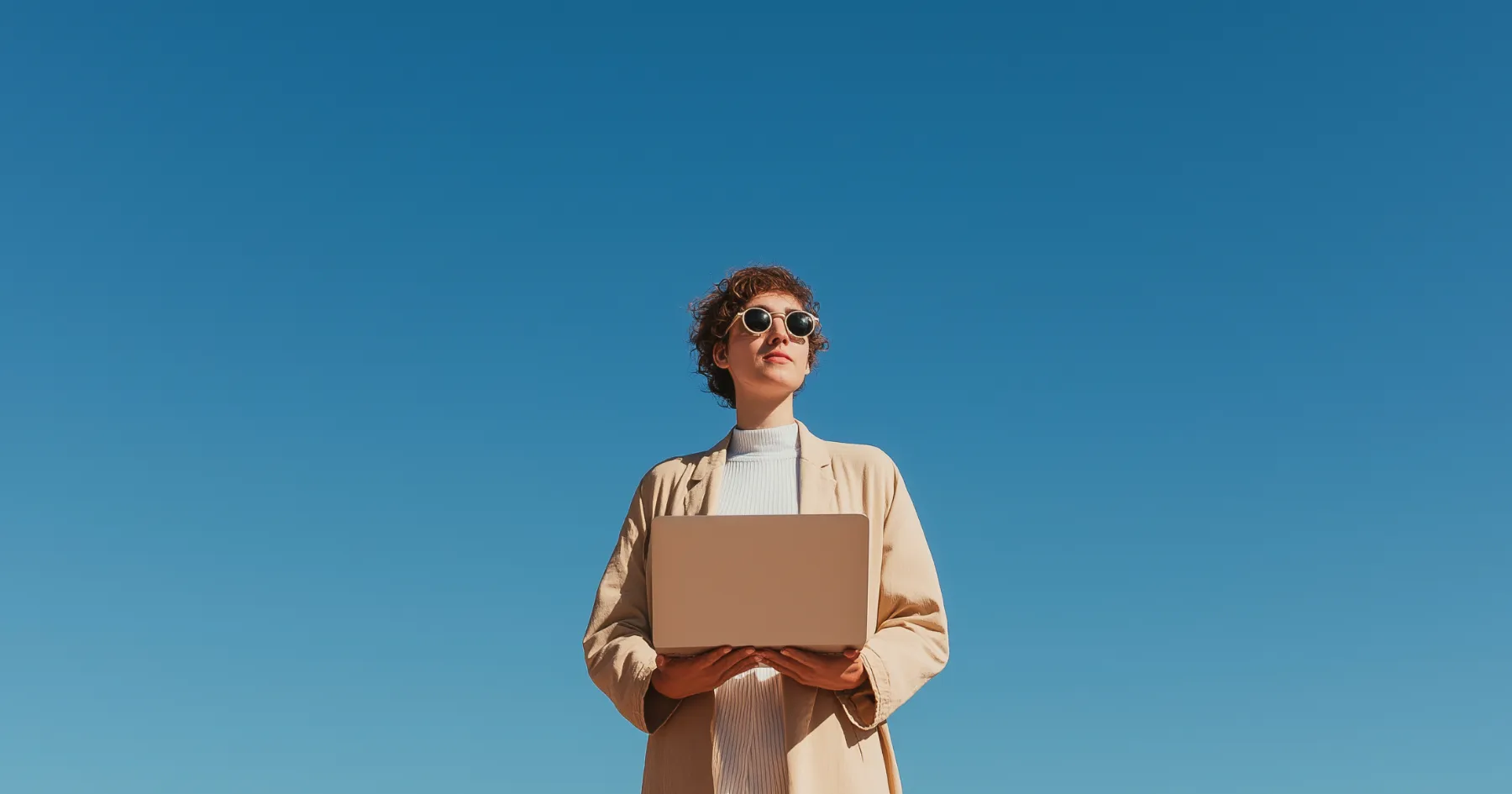Overhead view of a freelancer working on a laptop, representing the simplicity and efficiency of using freelance invoice templates.
